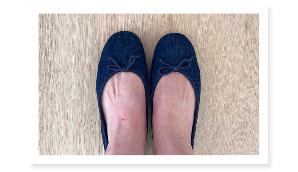 Showing how much toe cleavage there is in Reformation ballet flats