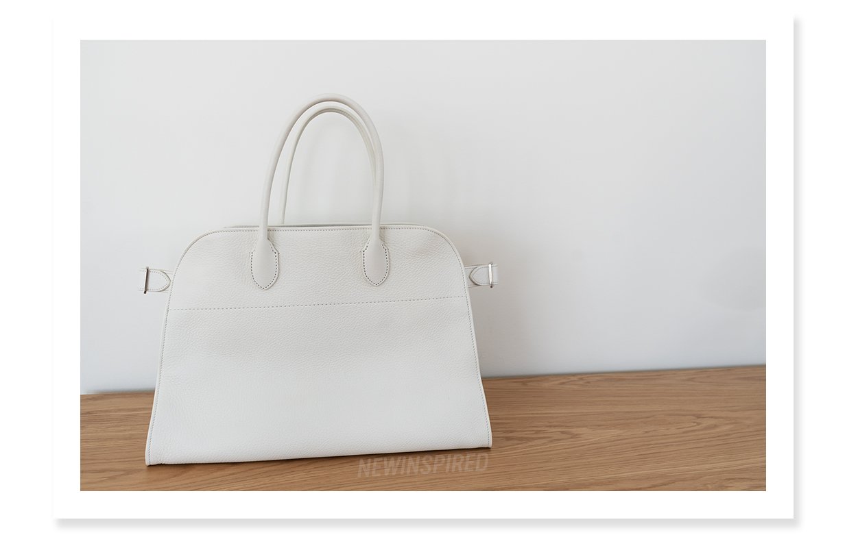 The Row Margaux 15 bag, in white on a white oak table